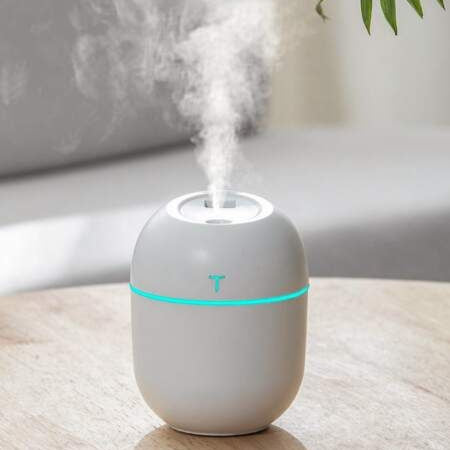 White humidifier with steam rising in Room
