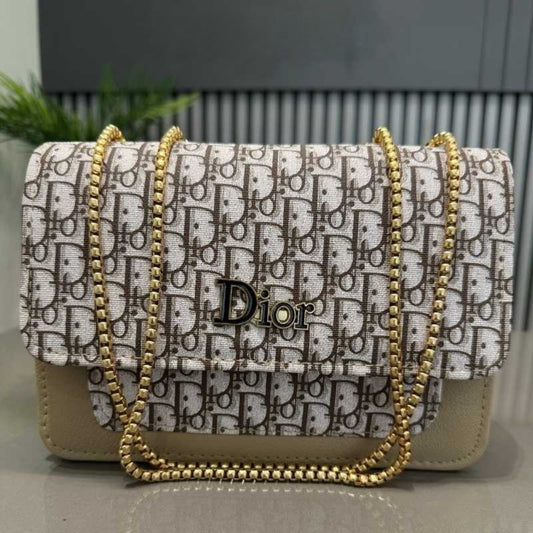 Dior handbag with gold chain strap on a neutral background