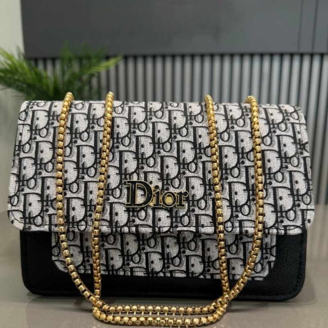 Dior handbag with gold chain strap on a neutral background