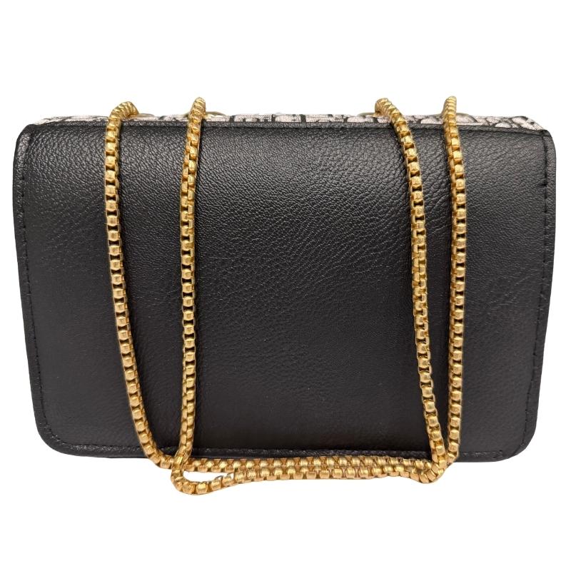 Black handbag with a gold chain strap on a white background