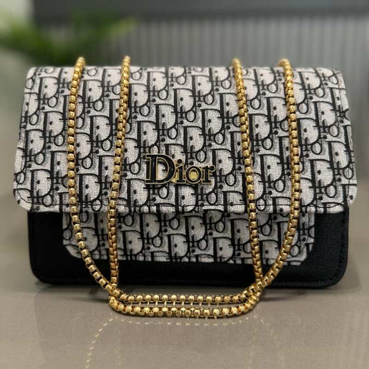 Designer handbag with gold chain strap and Dior logo on a neutral background