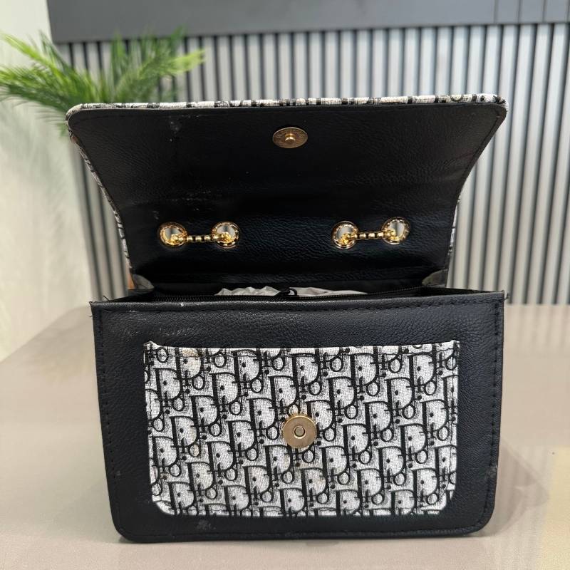 Black leather wallet with patterned flap on a light surface