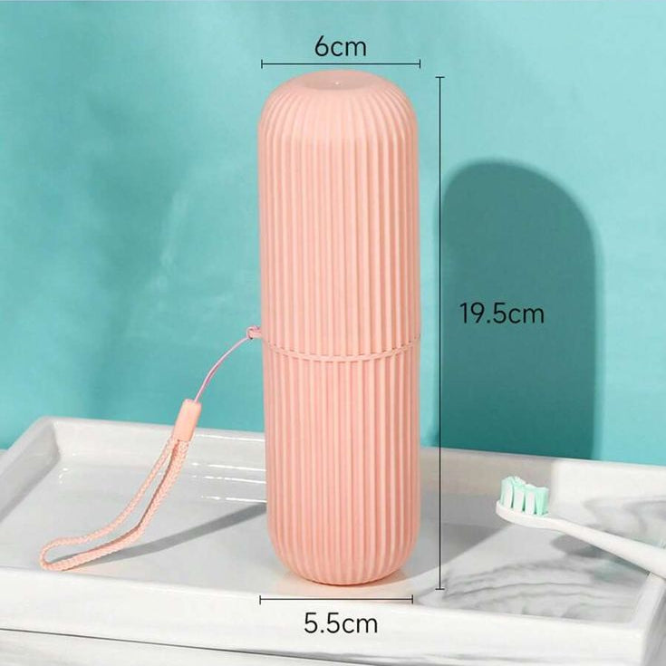 Pink travel toothbrush case with measurements on a light blue background