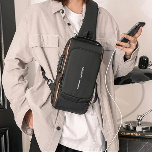 Person wearing a black crossbody bag with 'FASHION' branding, holding a phone.