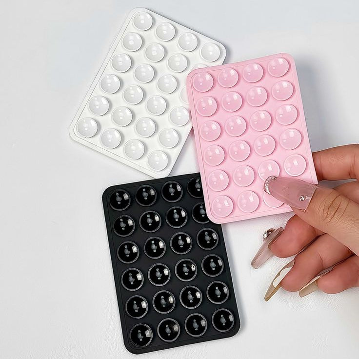 Three silicone bubble molds in white, pink, and black on a light gray background.