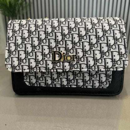 Dior handbag with black and white pattern on a light gray background