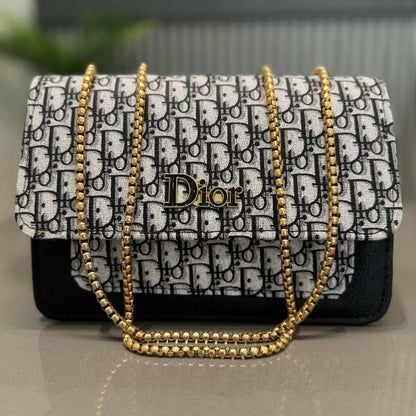 Designer handbag with gold chain strap and Dior logo on a neutral background