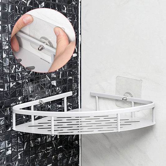 White corner shower caddy attached to a tiled shower wall.